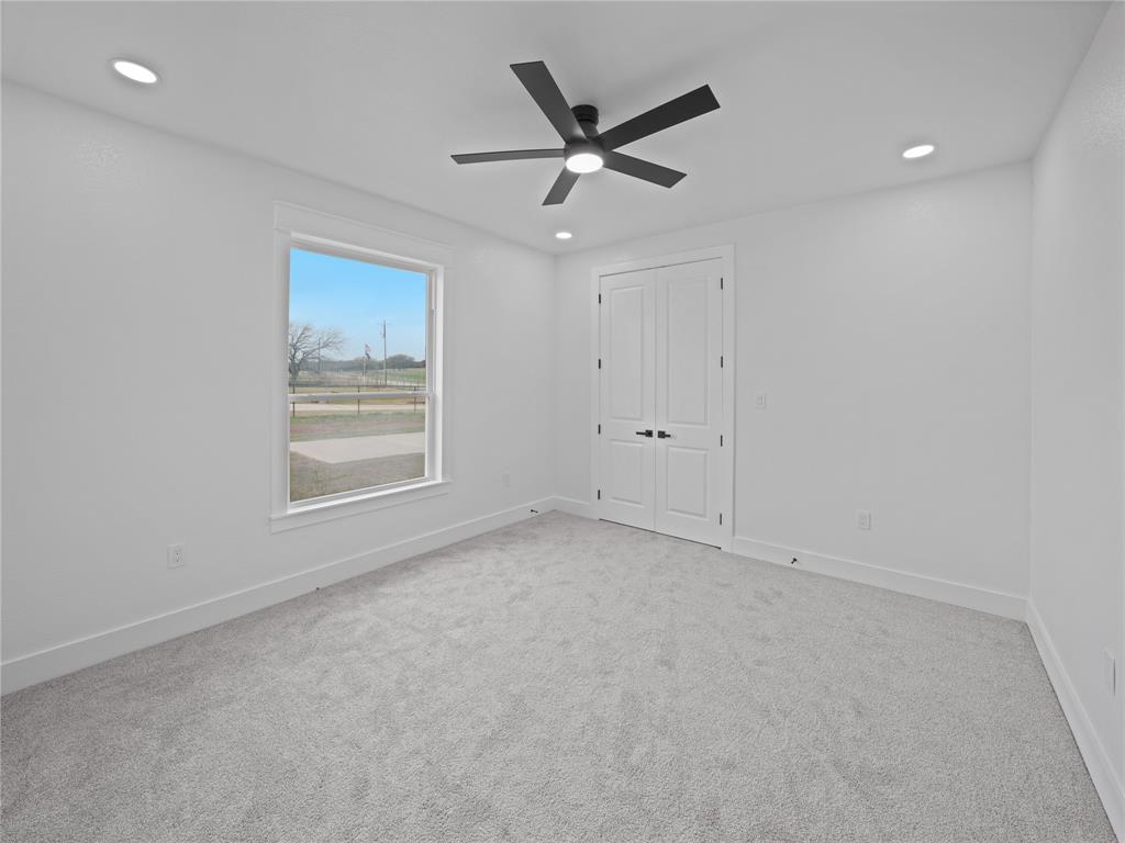 145 Cartwright Park Road Weatherford, TX 76087 - Photo 20 of 27 an empty room with a ceiling fan and window