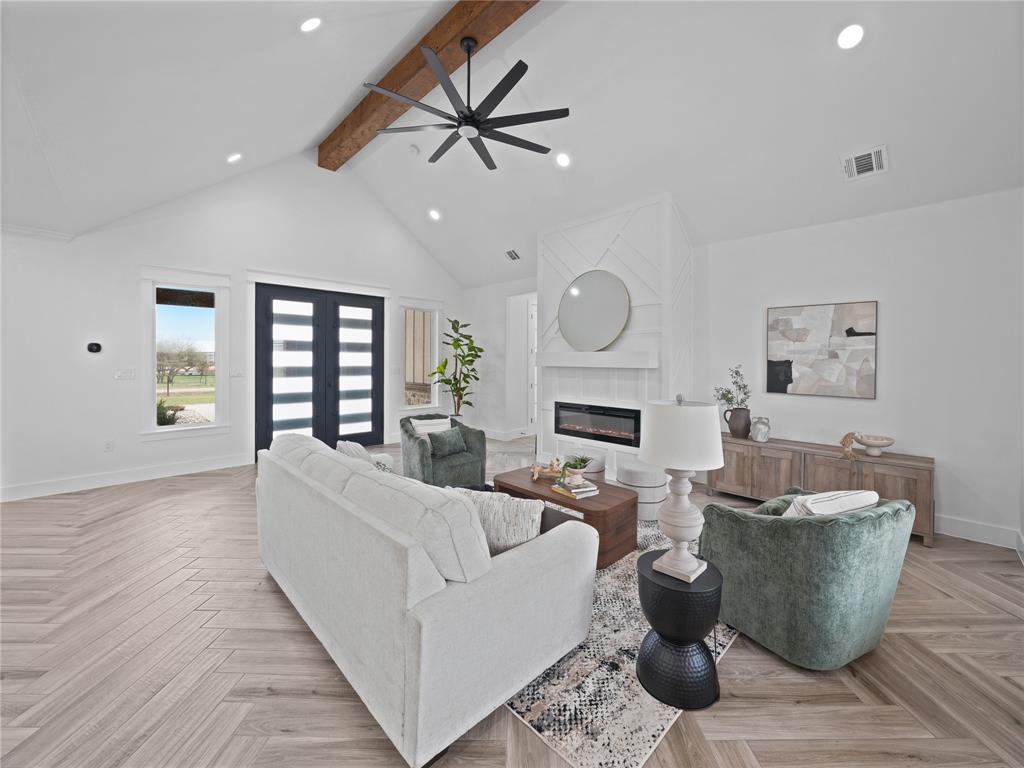 145 Cartwright Park Road Weatherford, TX 76087 - Photo 5 of 27 a living room with furniture a fireplace and a ceiling fan