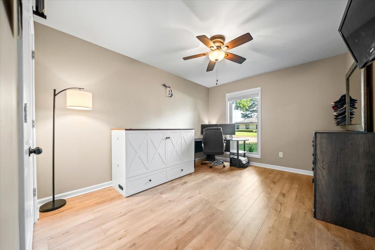 4686 Bill Knight Road Millington, TN 38053 - Photo 21 of 29 Room featuring wood-finish flooring, a ceiling fan with integrated lighting, and a single window with white trim