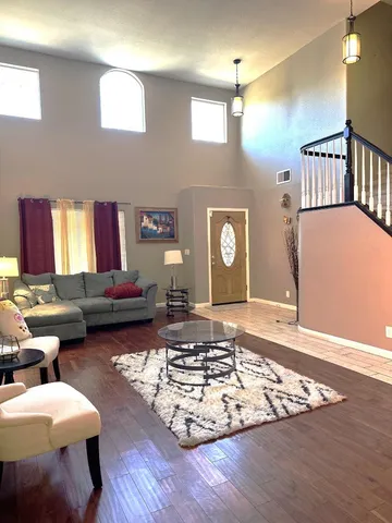 a living room with lots of furniture and a rug