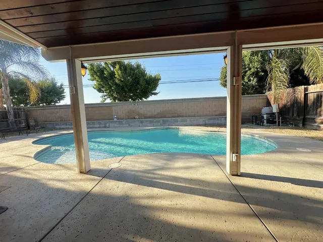 a view of a swimming pool with a yard