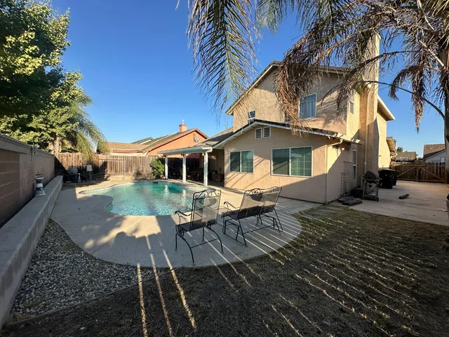 a view of a backyard with sitting area