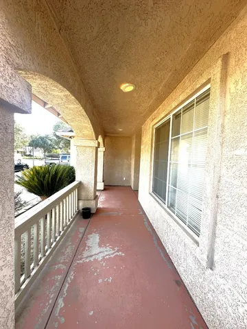 a view of a porch with wooden floor and fence