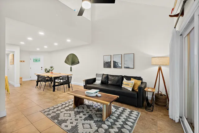 a living room with furniture a rug and a large window