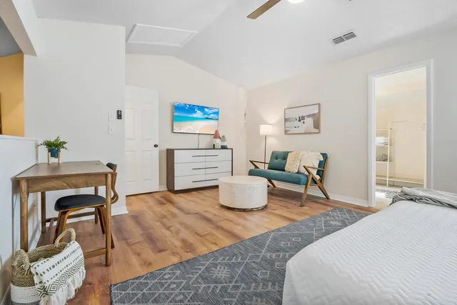 a bedroom with a bed and wooden floor