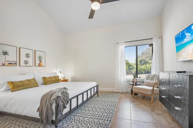 a bedroom with a bed and a couch