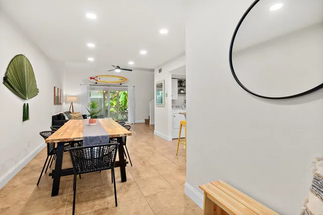 a dining room with furniture and a mirror