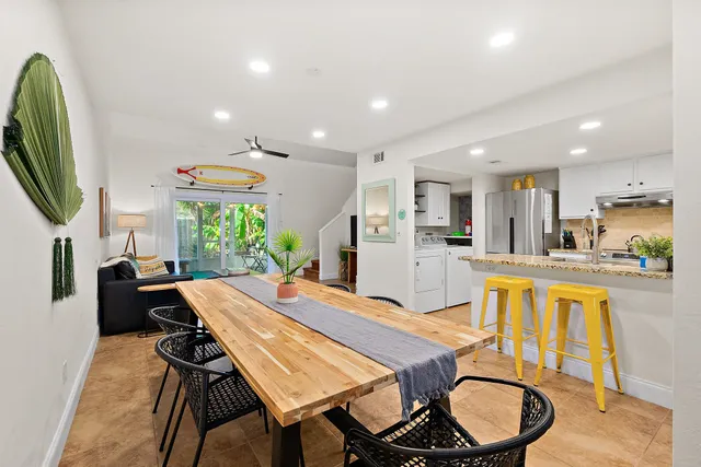 a dining room with furniture and a kitchen view