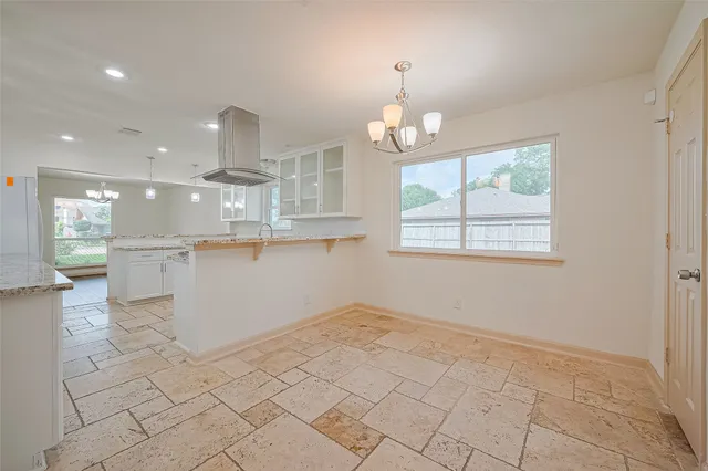 a view of a kitchen with marble kitchen and center island