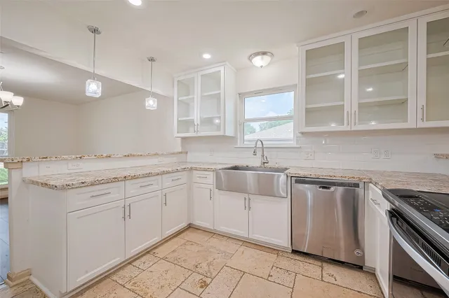 a kitchen with granite countertop white cabinets and white appliances