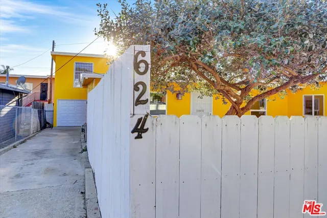 a sign board with buildings in the background