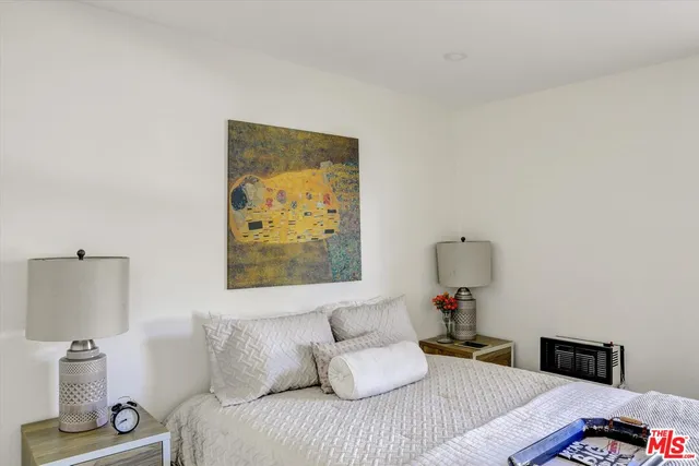 a bedroom with a bed and a lamp on table