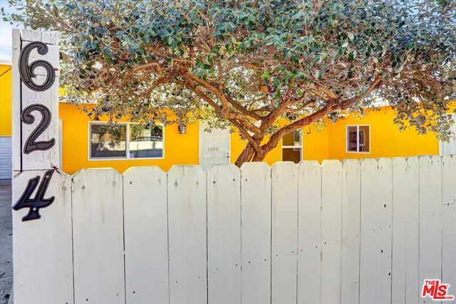 a street sign on a sidewalk next to a road