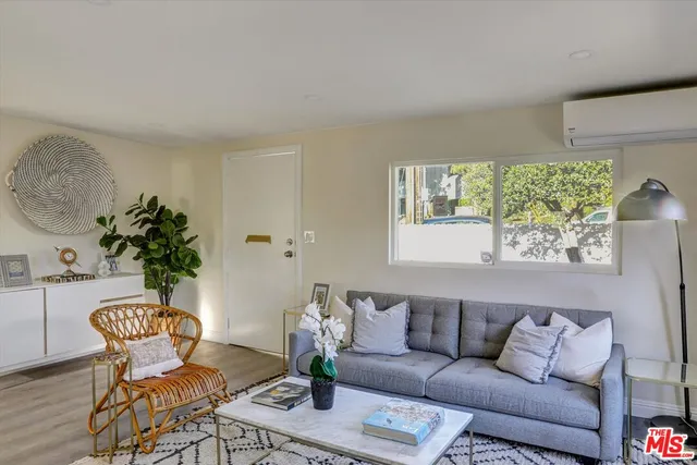 a living room with furniture and a potted plant