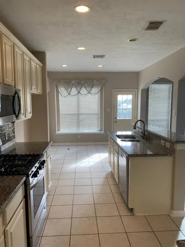 a view of staircase with white walls and a window