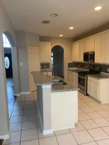 en empty room with windows and yard