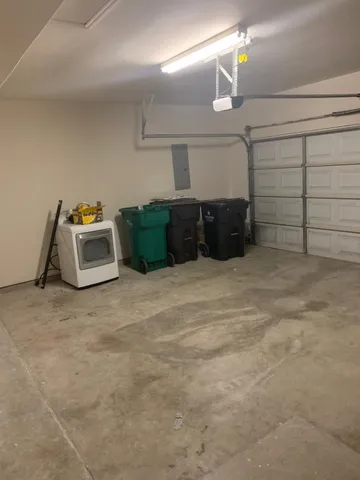 a view of yard with seating space and trees in the background