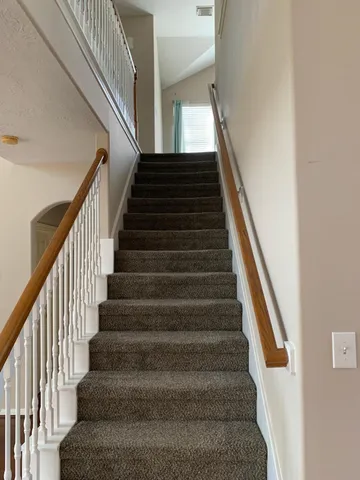 a view of a house with yard and tree s