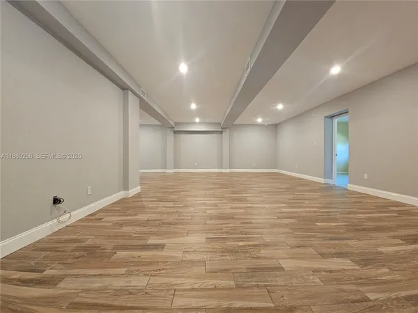 an empty room with wooden floor