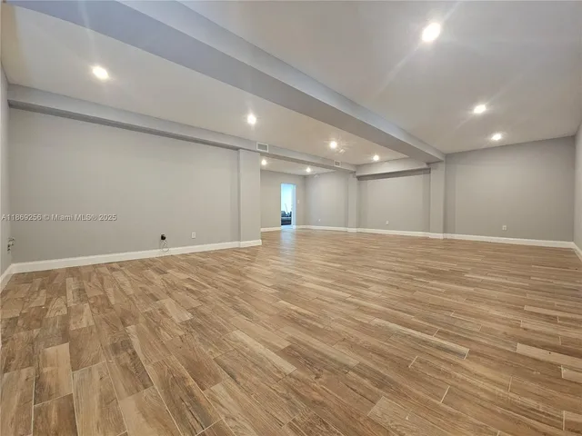 an empty room with wooden floor