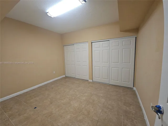 an empty room with closet area