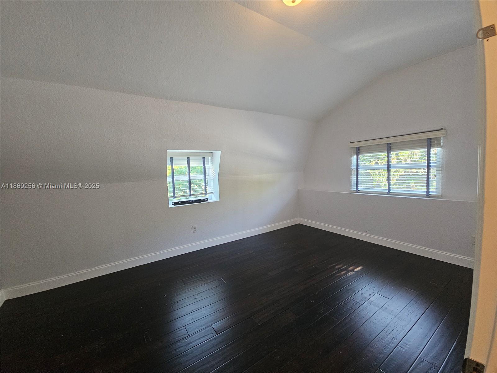 15101 Southwest 27th Street Davie, FL 33331 - Photo 40 of 43 a view of an empty room with wooden floor and a window
