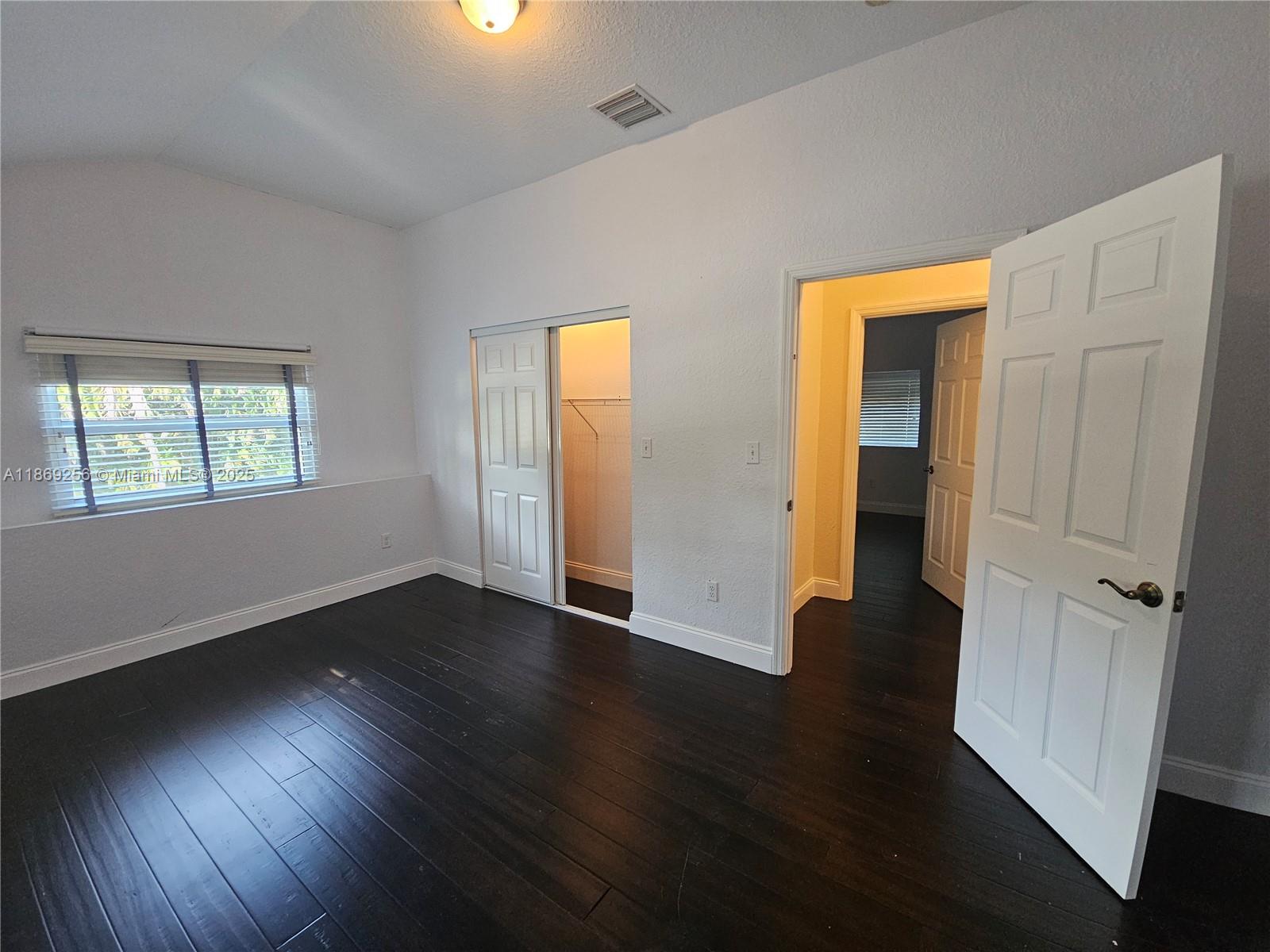 15101 Southwest 27th Street Davie, FL 33331 - Photo 41 of 43 a view of an empty room with wooden floor and a window