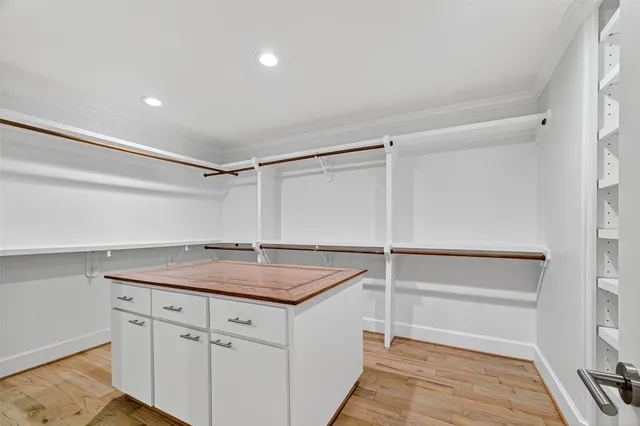 a view of a porch with wooden floor and iron gate