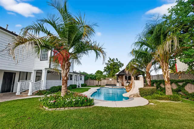 a view of a chair and table in the garden