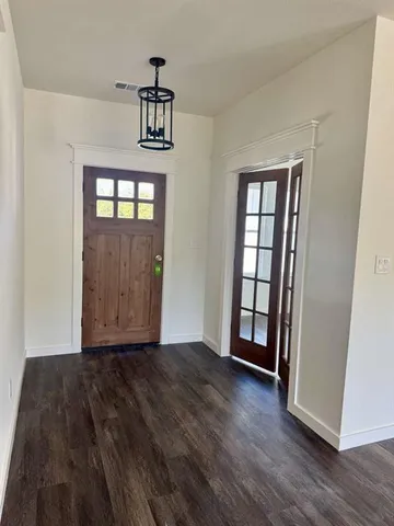 a kitchen with kitchen island white cabinets stainless steel appliances and wooden floor
