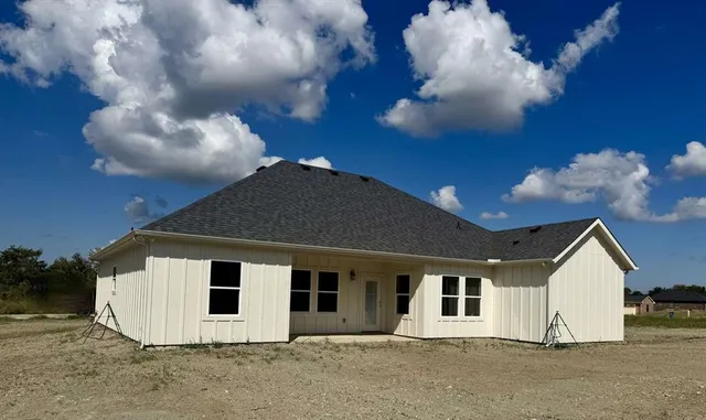 a view of a white house with a yard