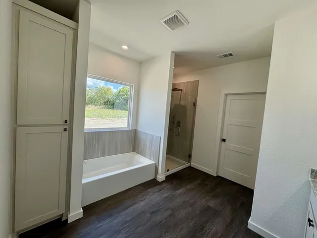 a bathroom with a bathtub and a shower