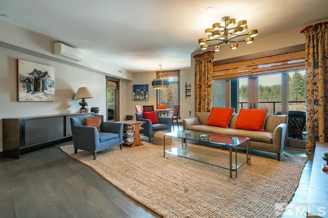 a living room with furniture and a chandelier