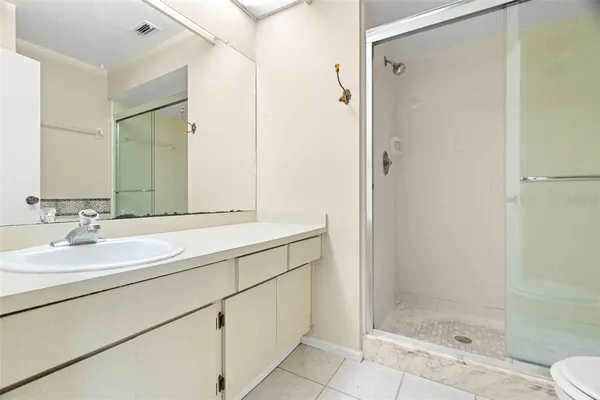 a bathroom with a glass shower door