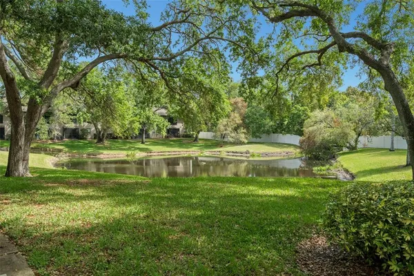 a view of a house with swimming pool and sitting area