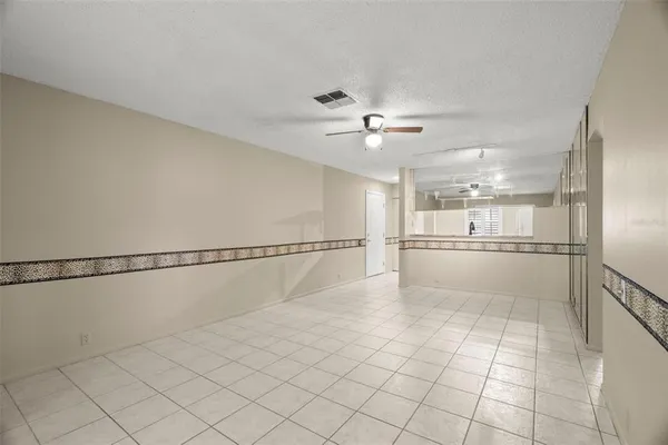a view of a ceiling fan and a rug
