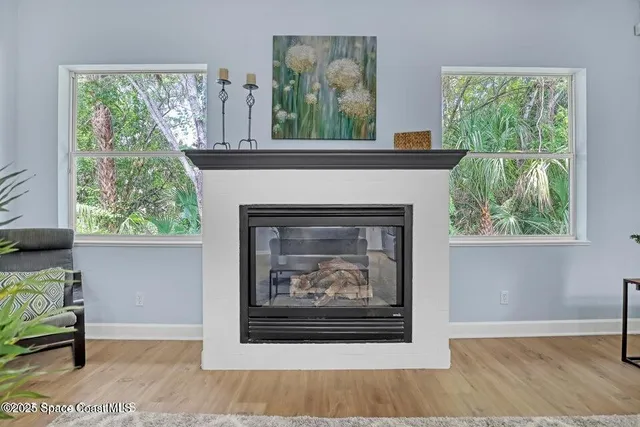 a living room with a fireplace and a window