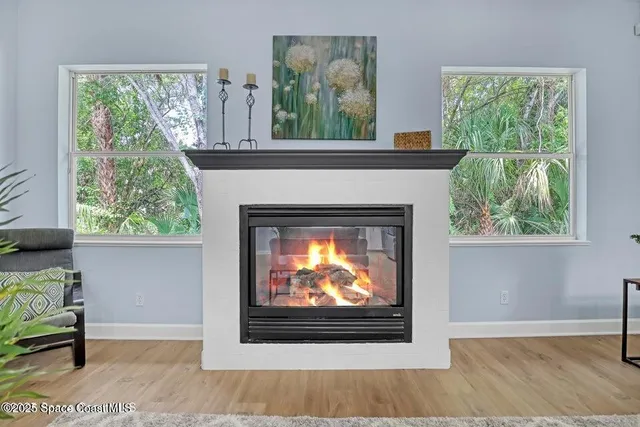 a living room with a fireplace and a flat screen tv