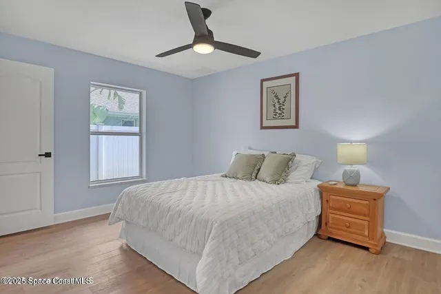 a bedroom with a bed and a night stand