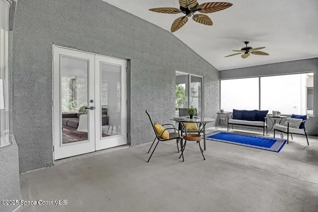 a view of a livingroom with furniture and a ceiling fan