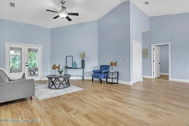 a living room with furniture and a wooden floor