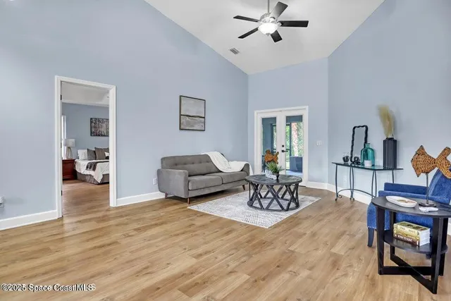 a living room with furniture and a wooden floor