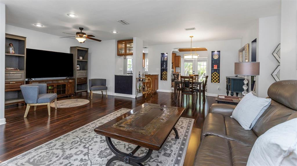 a living room with furniture a rug and a flat screen tv