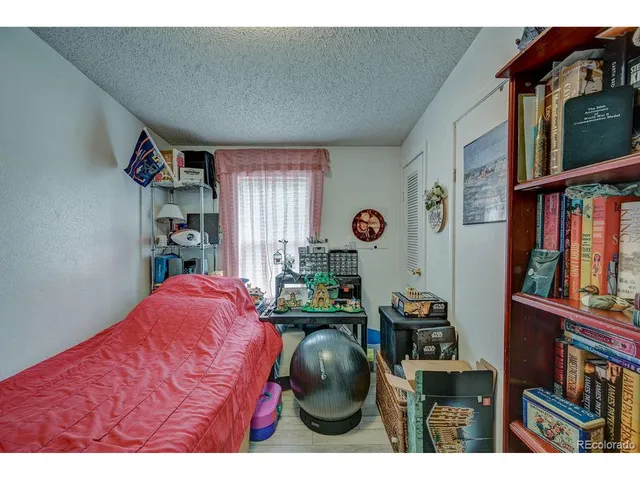 a bedroom with furniture and a book shelf