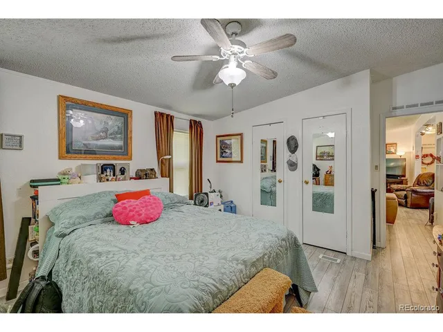 a bed room with a bed and a chandelier