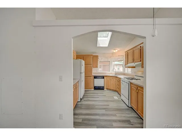 a kitchen with stainless steel appliances granite countertop a sink and cabinets