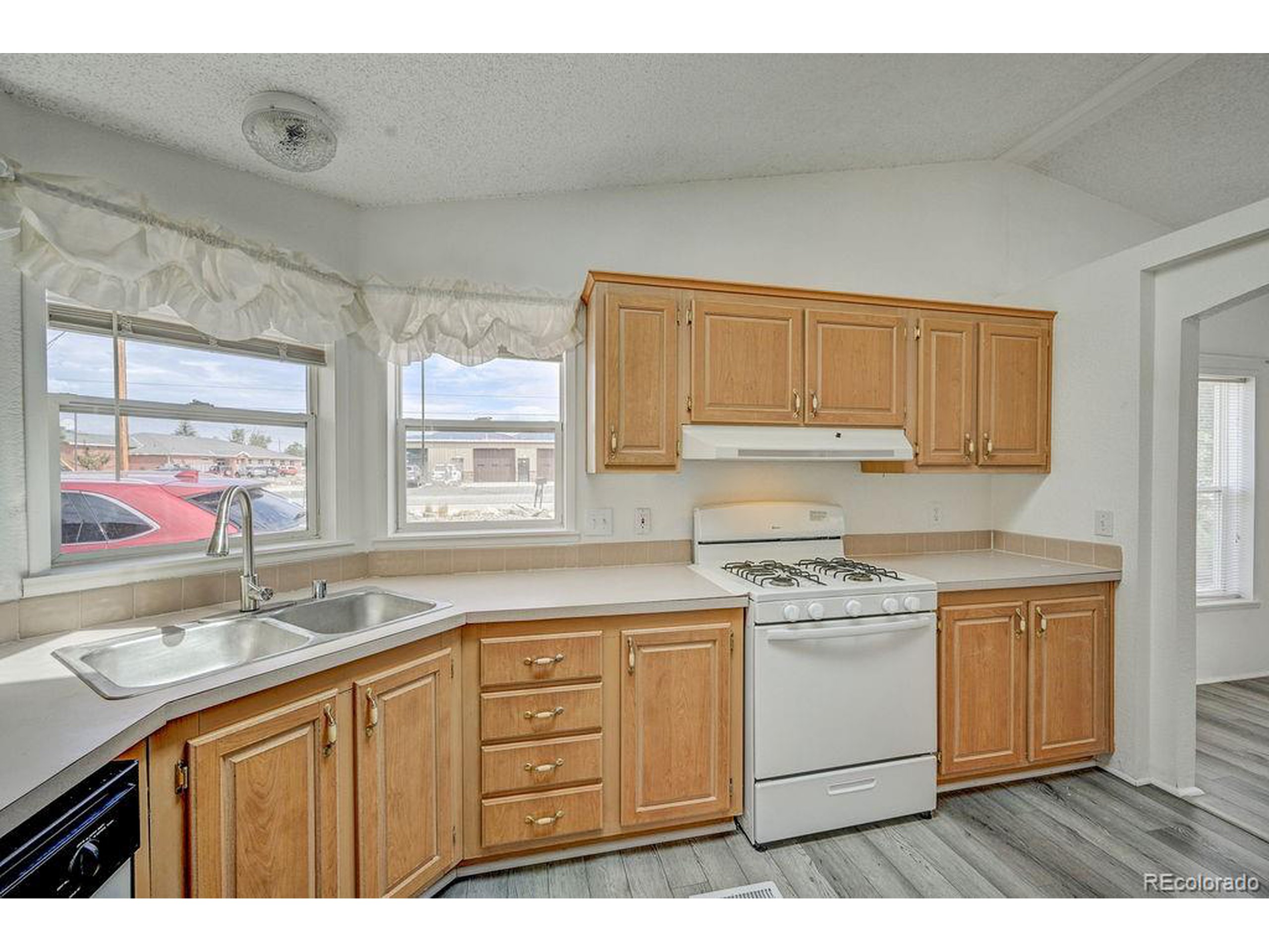 121 Brookdale Avenue Buena Vista, CO 81211 - Photo 21 of 50 a kitchen with a sink stove and cabinets
