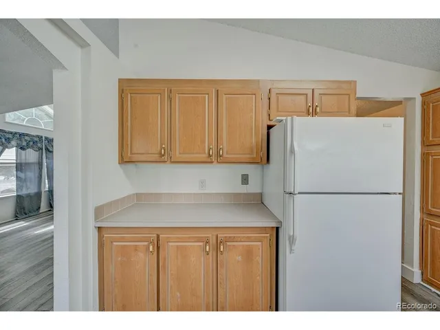 a white refrigerator freezer sitting in a kitchen