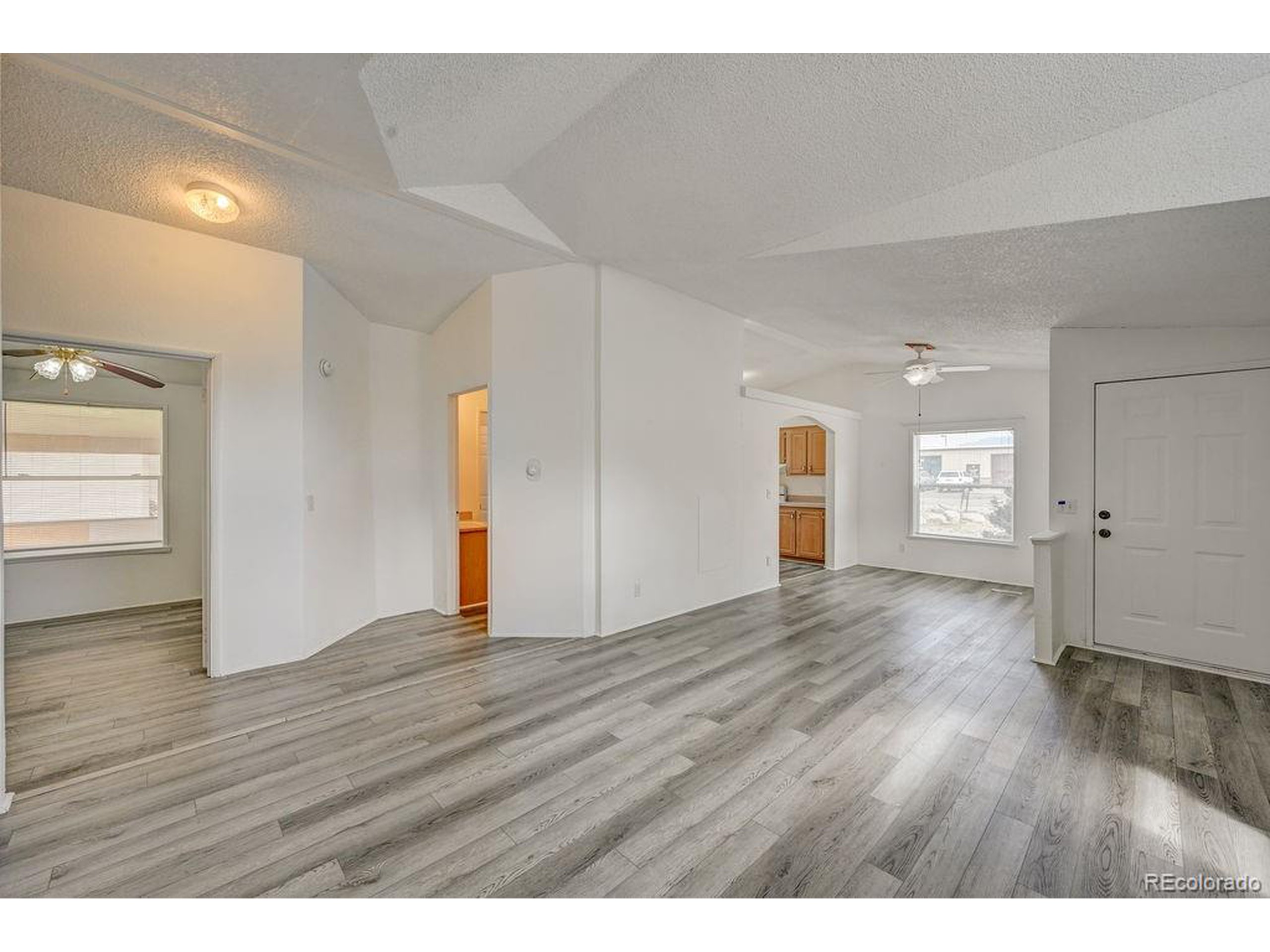 121 Brookdale Avenue Buena Vista, CO 81211 - Photo 23 of 50 a view of an empty room with wooden floor and window