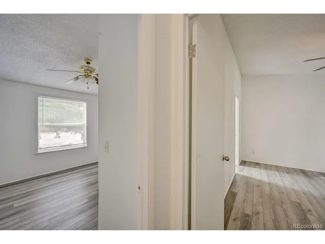 a view of an empty room and wooden floor